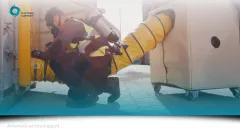 Man de-gassing a container.